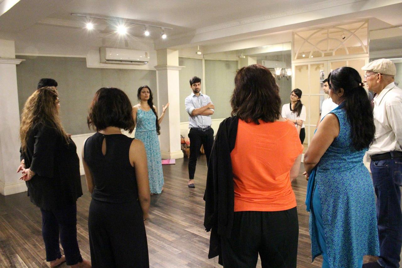 Swati speaking with an adult learning circle in a studio